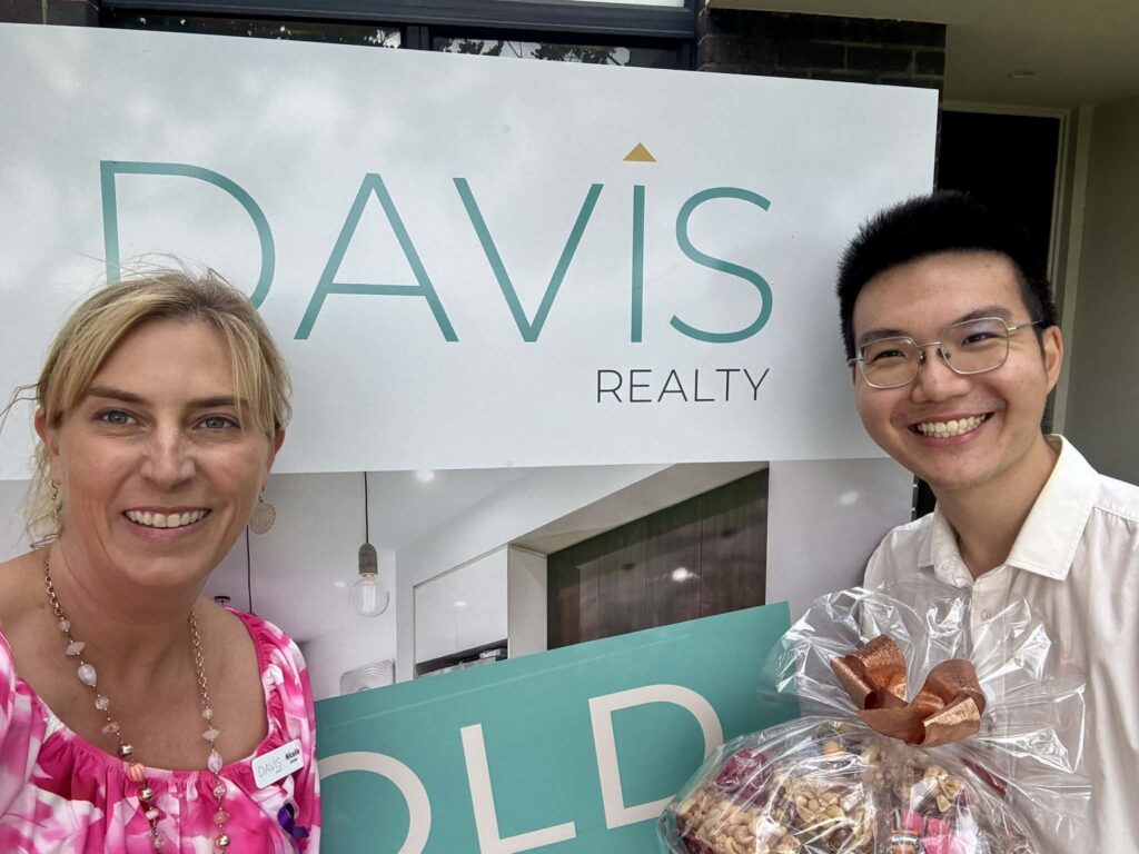 Nicolle Davis real estate agent in Adelaide with happy client after successful property sale